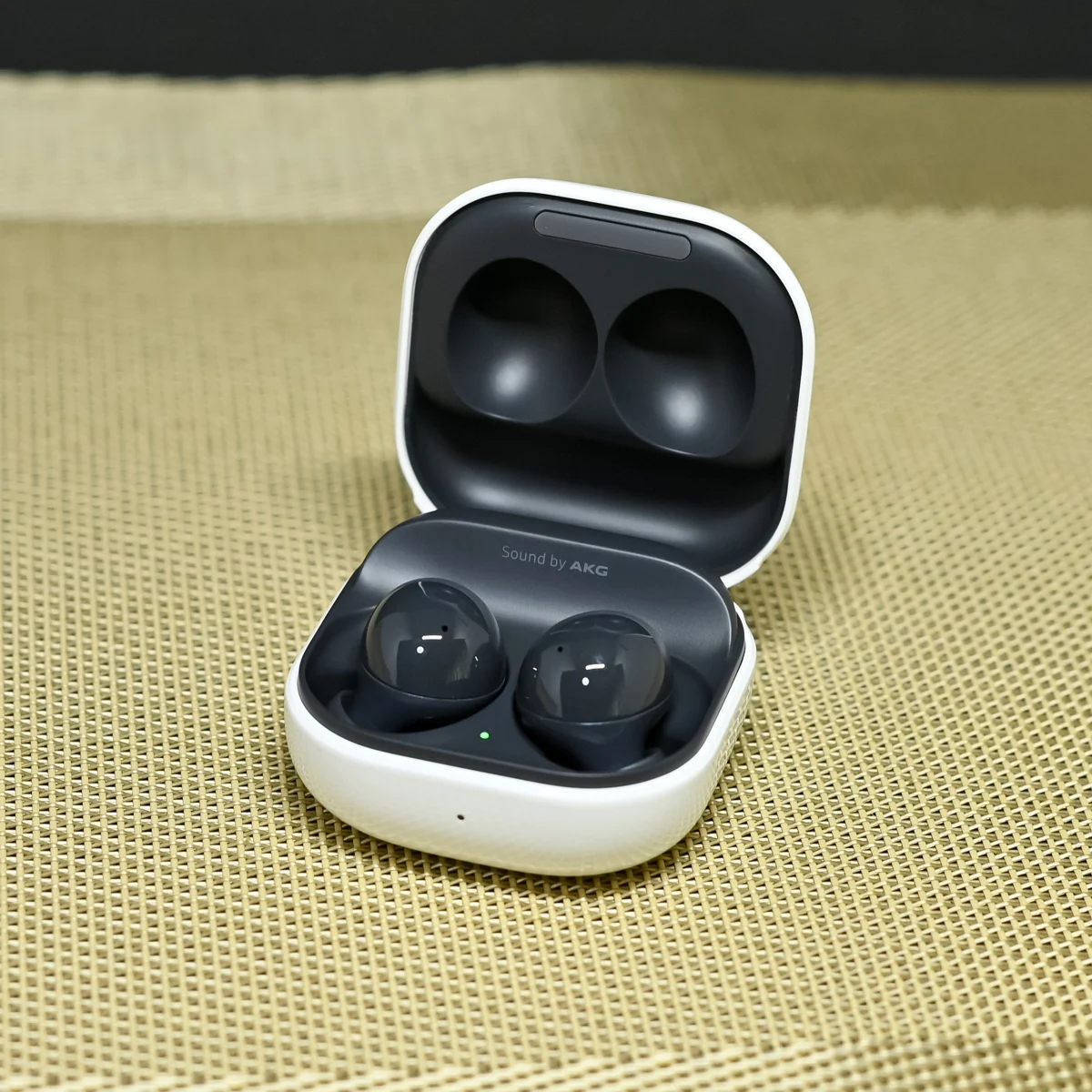 White wireless earbuds and their open charging case